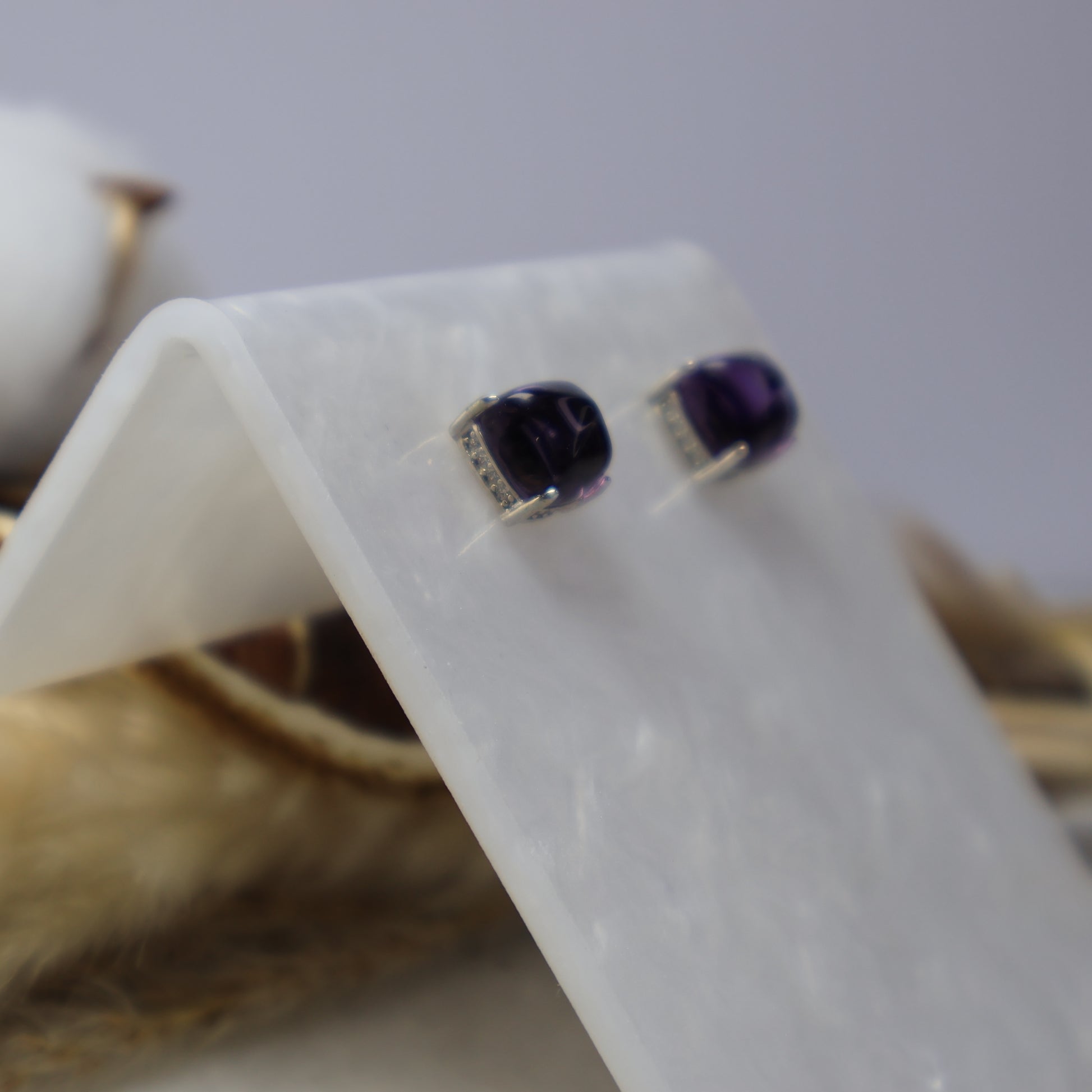 Close-up of natural 7mm amethyst stud earrings