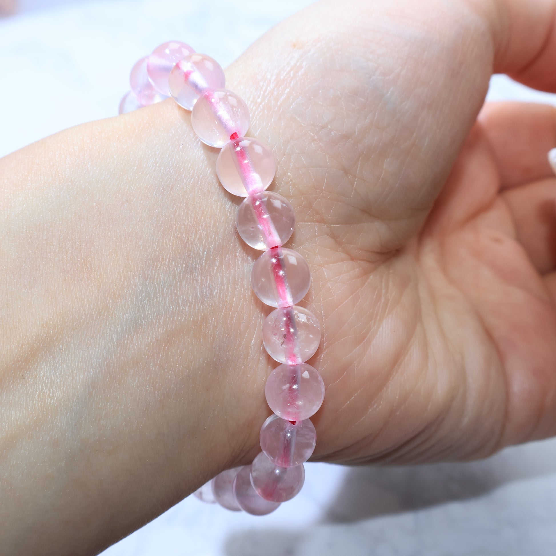 Front wrist view of Rose Quartz bracelet, highlighting its delicate pink hue.