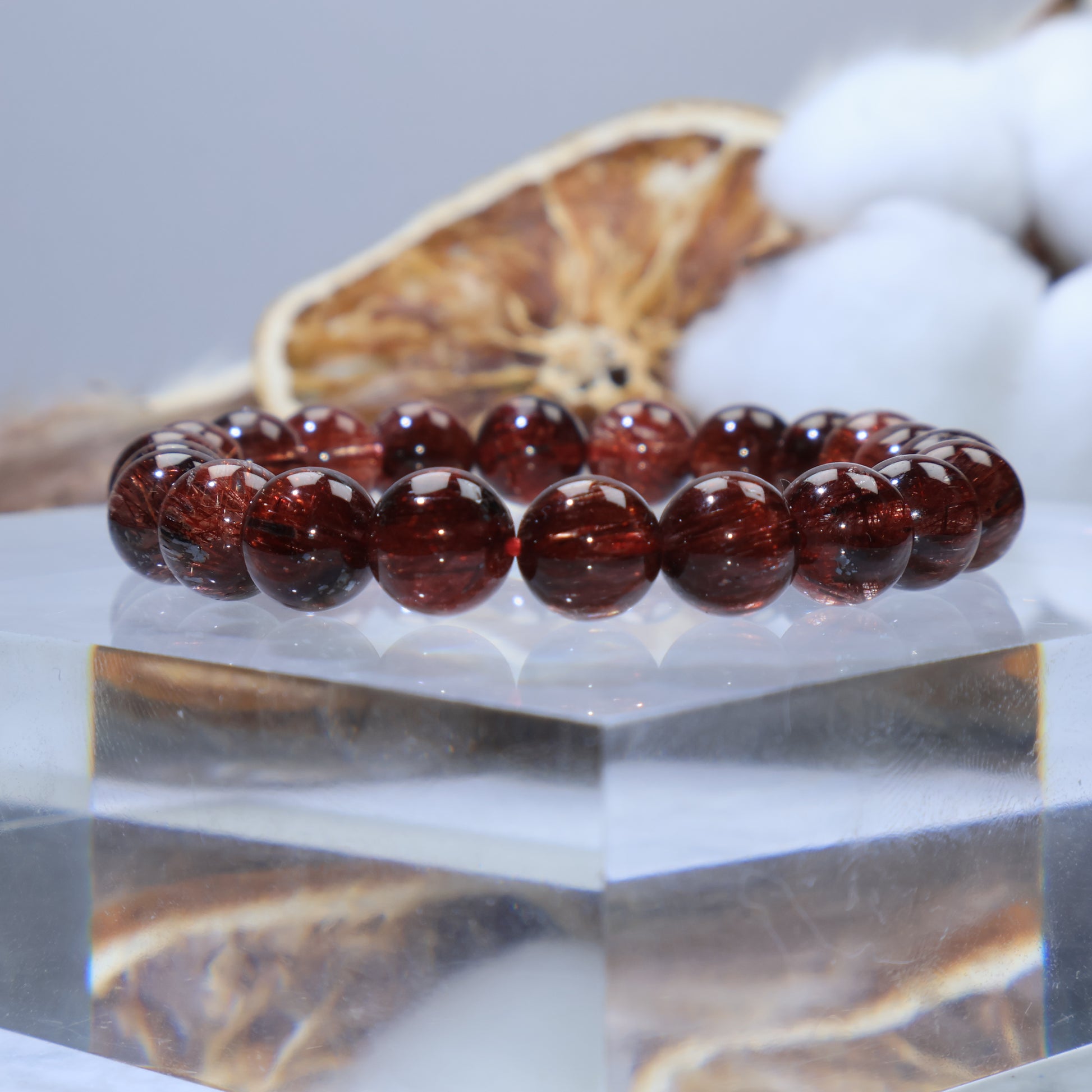 Side angle showing aligned copper-red rutile needles with glossy polish