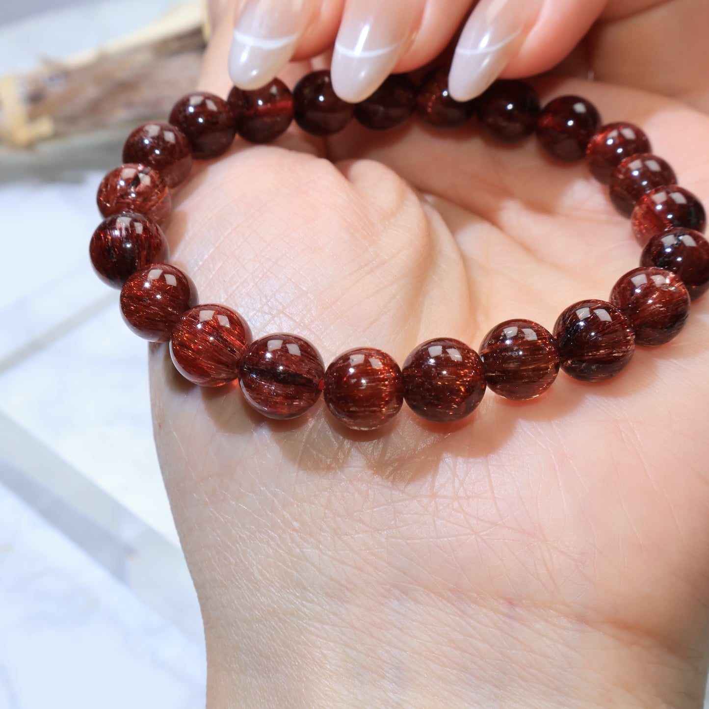 Palm view highlighting wine-red glow and even bead size