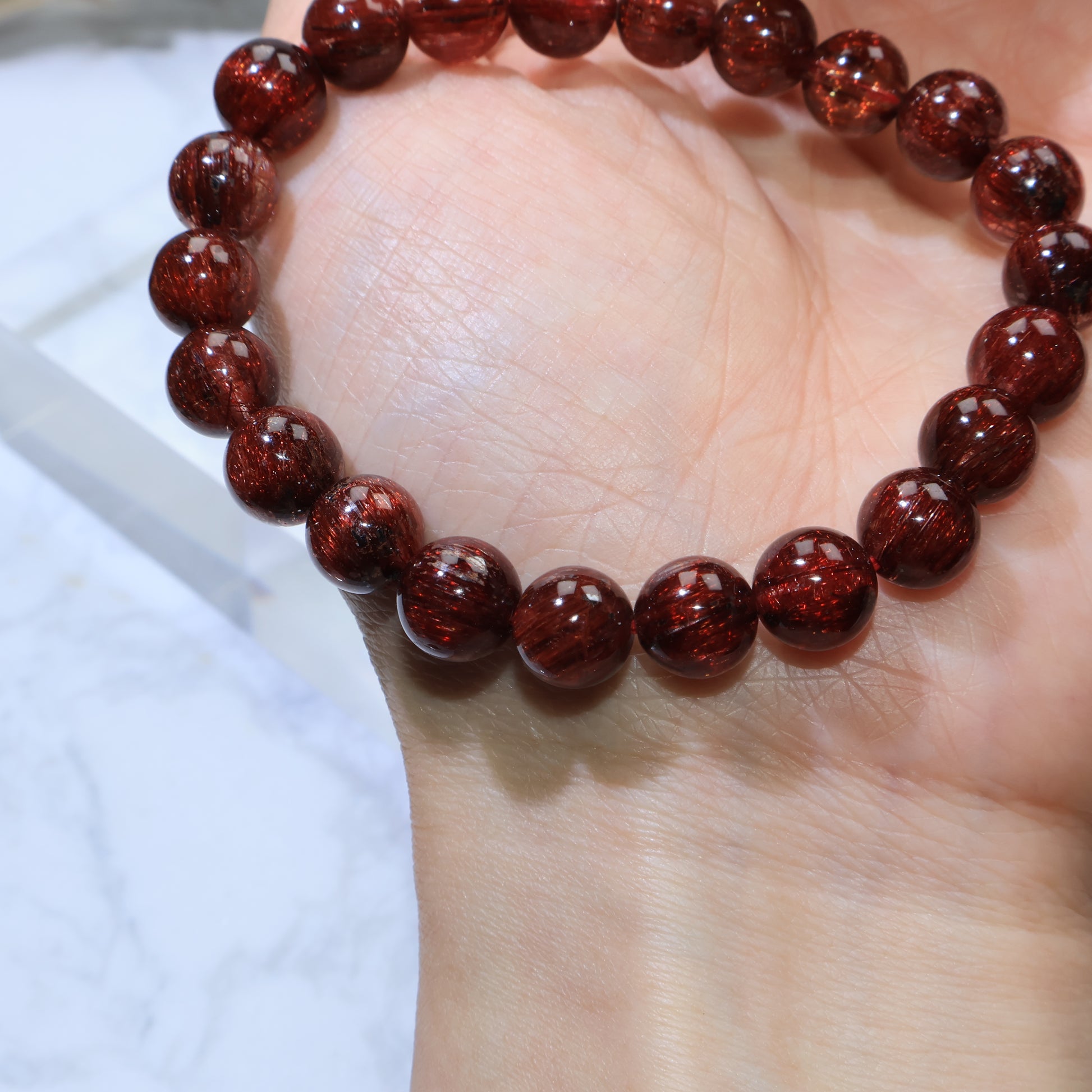 Palm view highlighting wine-red glow and even bead size