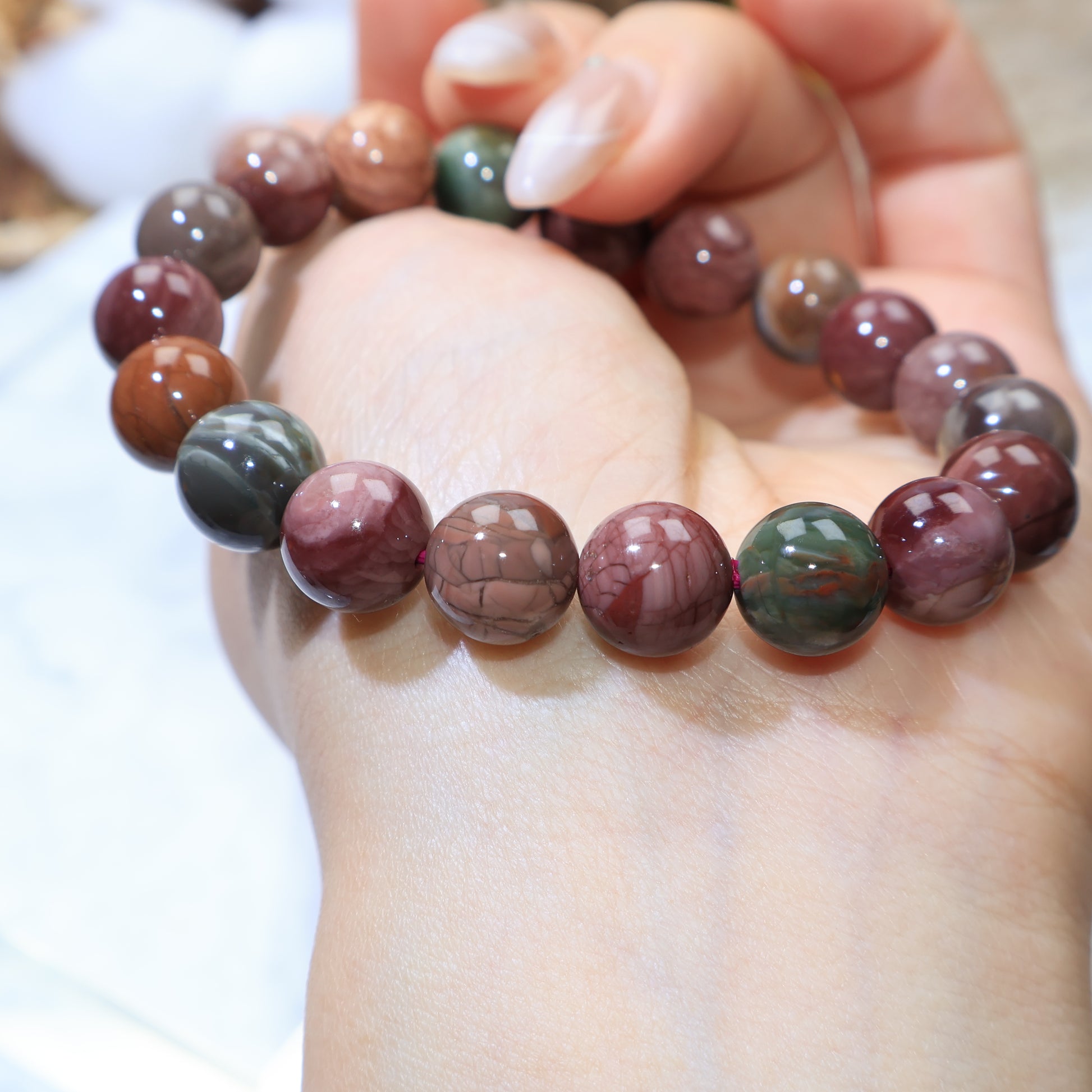 Macro wrist angle focusing on intricate patterns in Alxa Agate beads