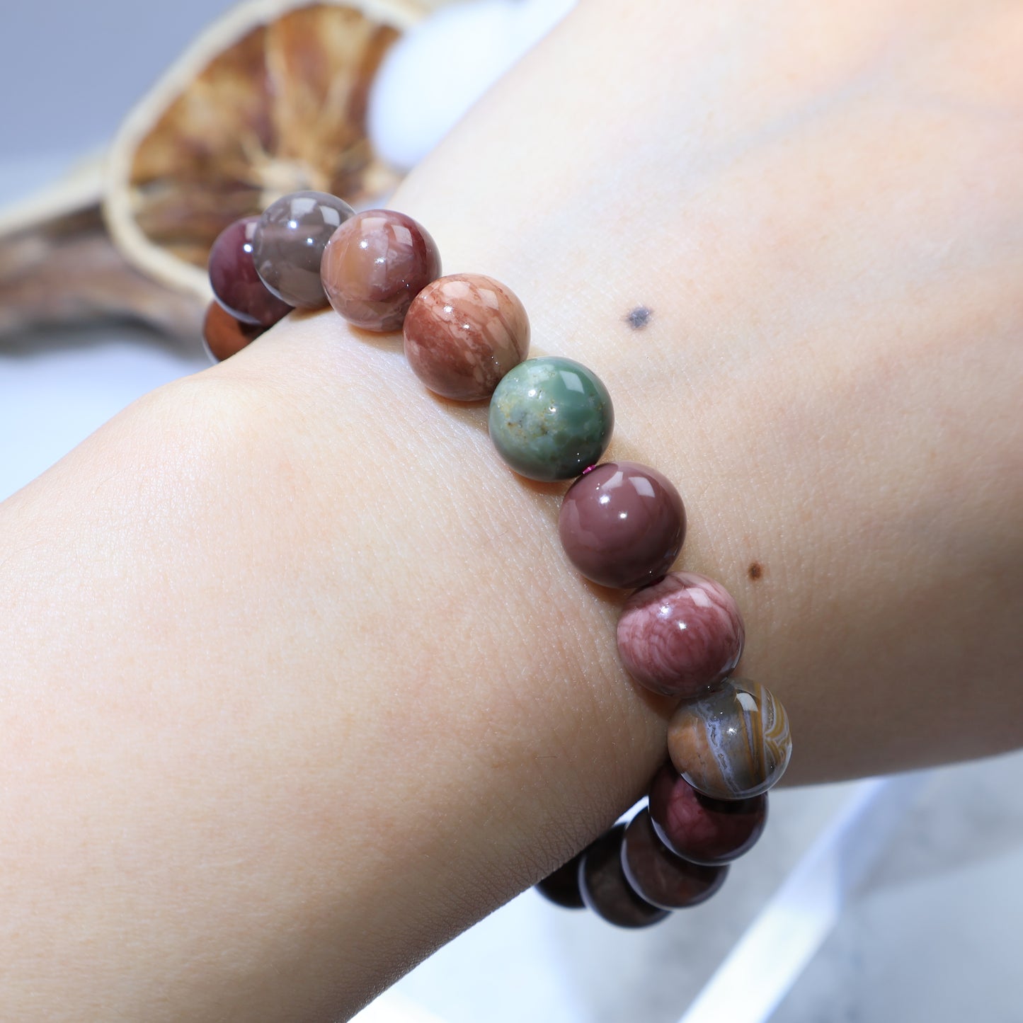 Wrist shot showing natural stone luster and variety of colors