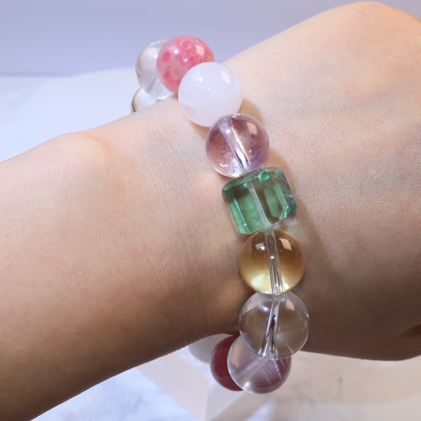 Side view of bracelet on wrist focusing on green fluorite and golden citrine