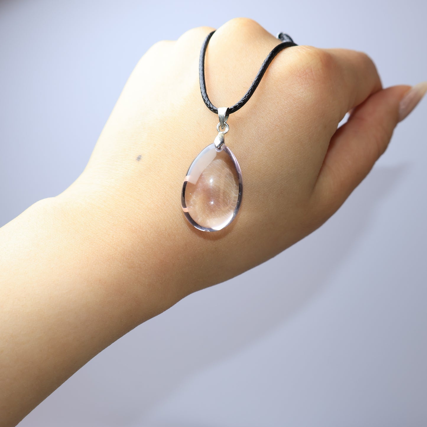Natural Amethyst pendant shown on hand for size