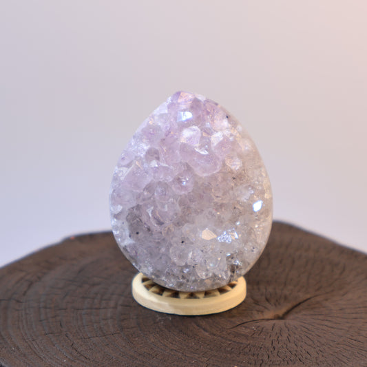 Front view of light lavender Amethyst egg with sparkling crystal clusters.
