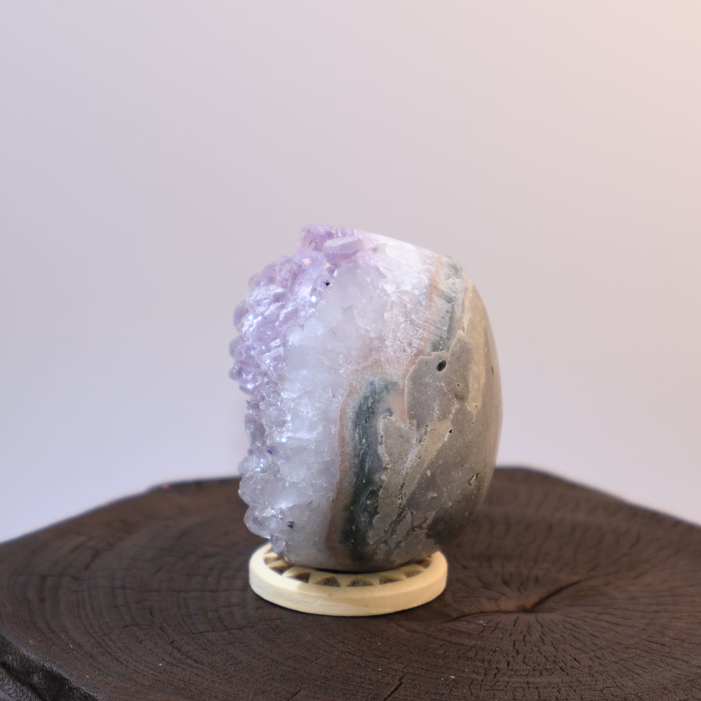 Side angle of Amethyst egg showing clusters and layered banding.