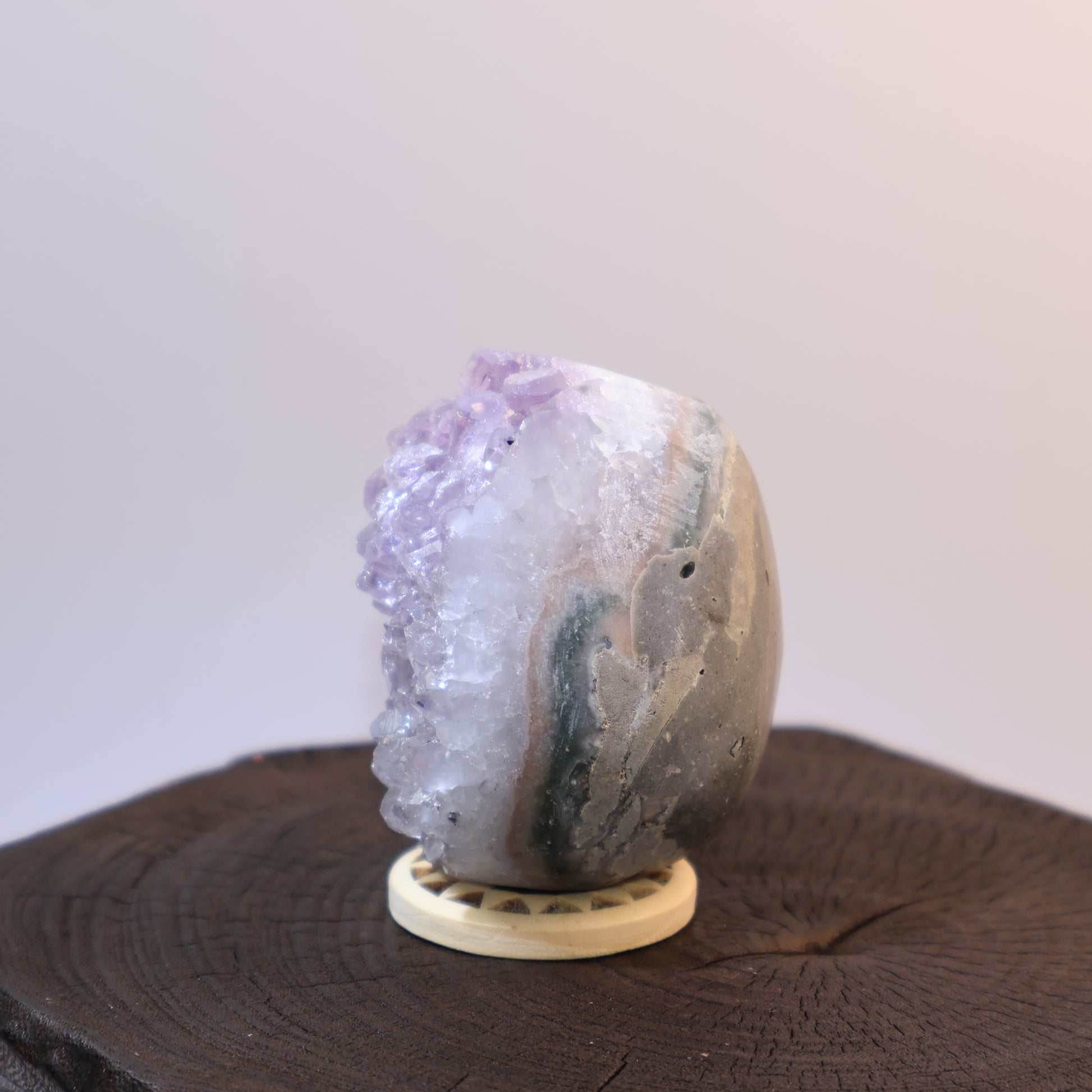 Side angle of Amethyst egg showing clusters and layered banding.