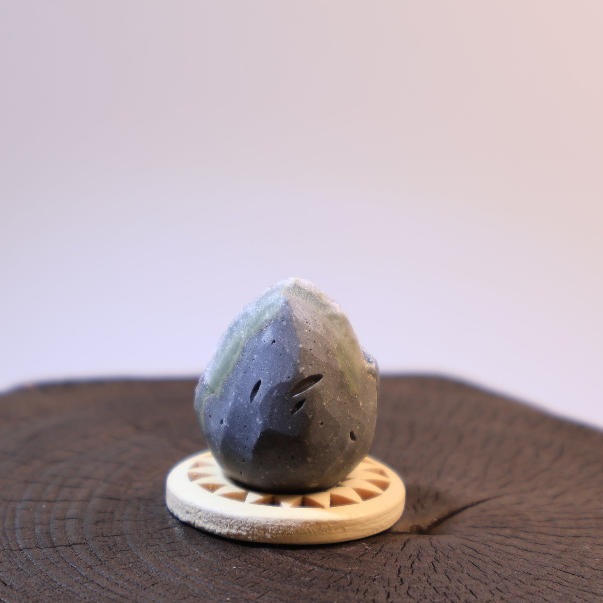 Back view of grey quartz geode egg with natural polished banding.