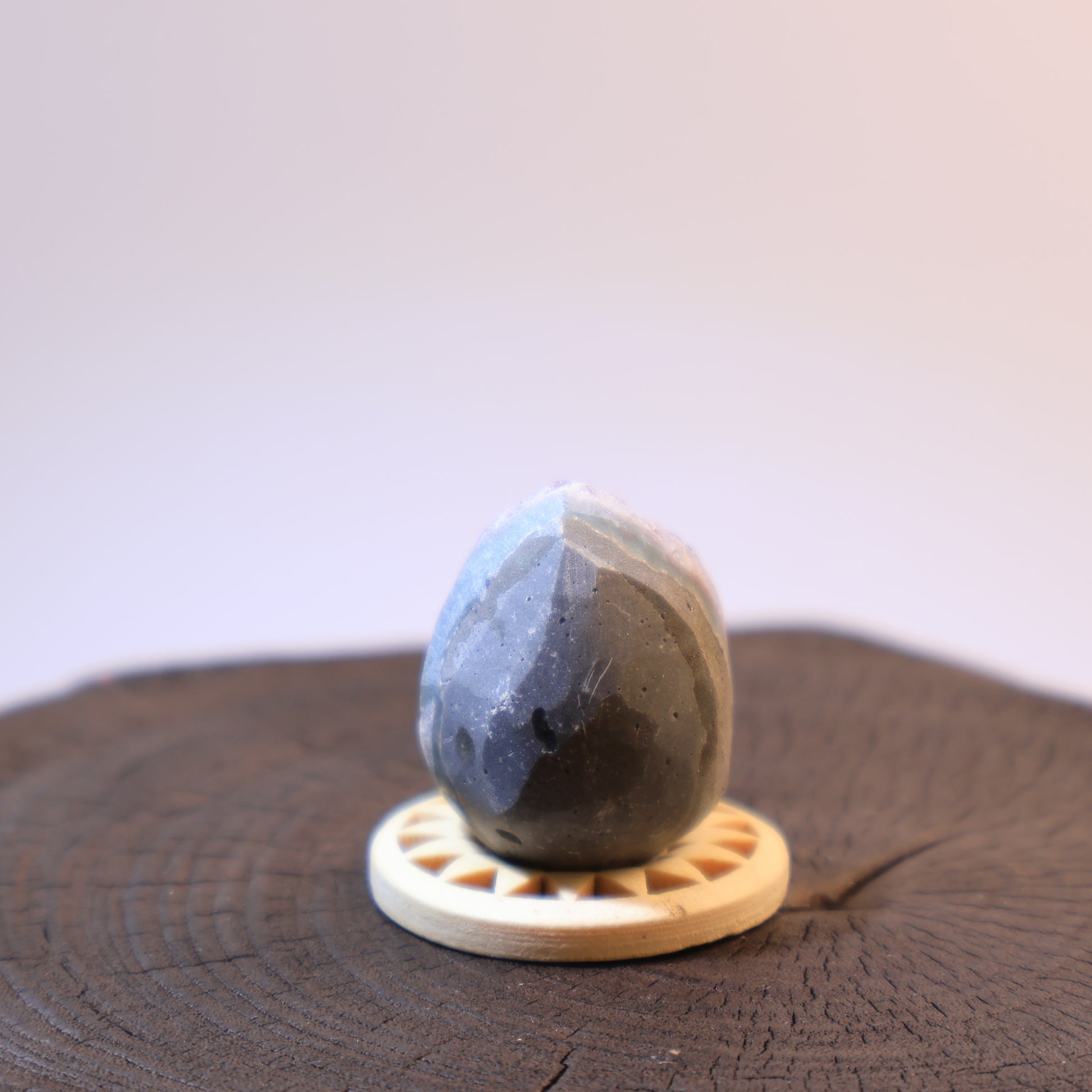 Back view of purple amethyst geode egg with natural texture.
