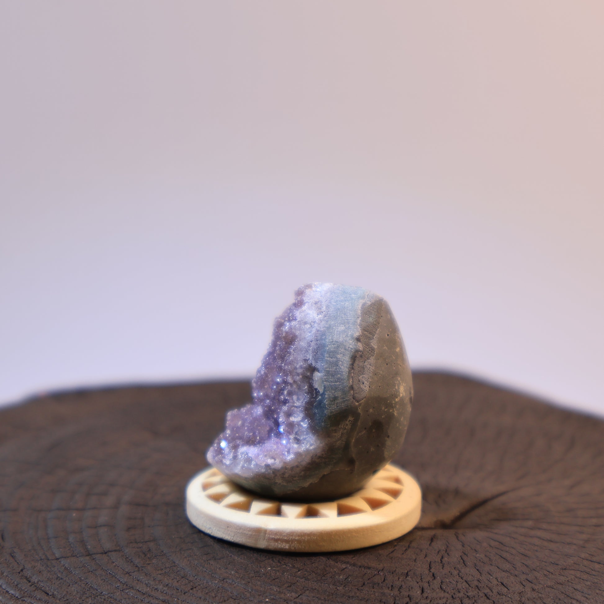 Alternate side of purple amethyst geode egg with visible banding.