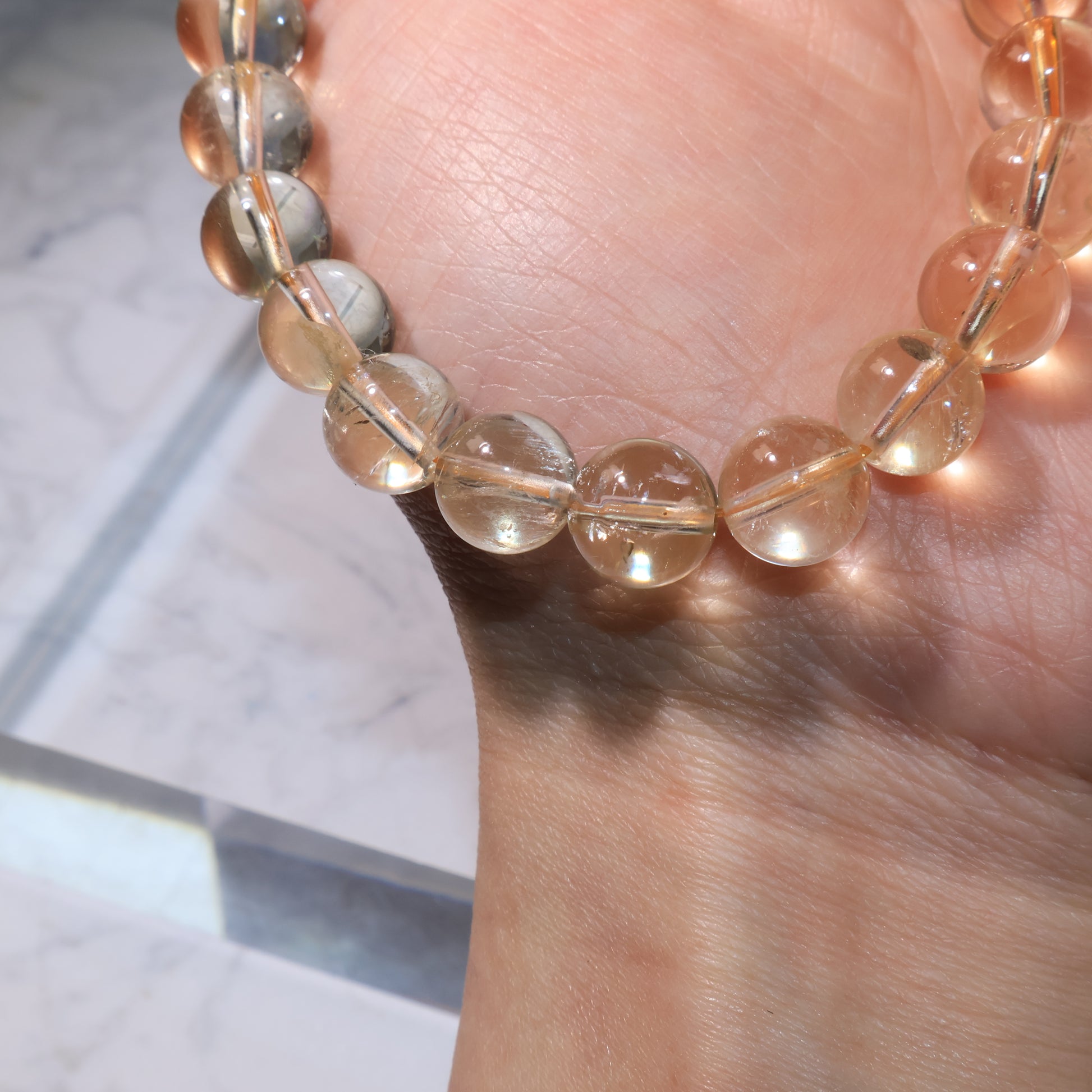 Detailed view of citrine beads with soft golden tone and internal textures.