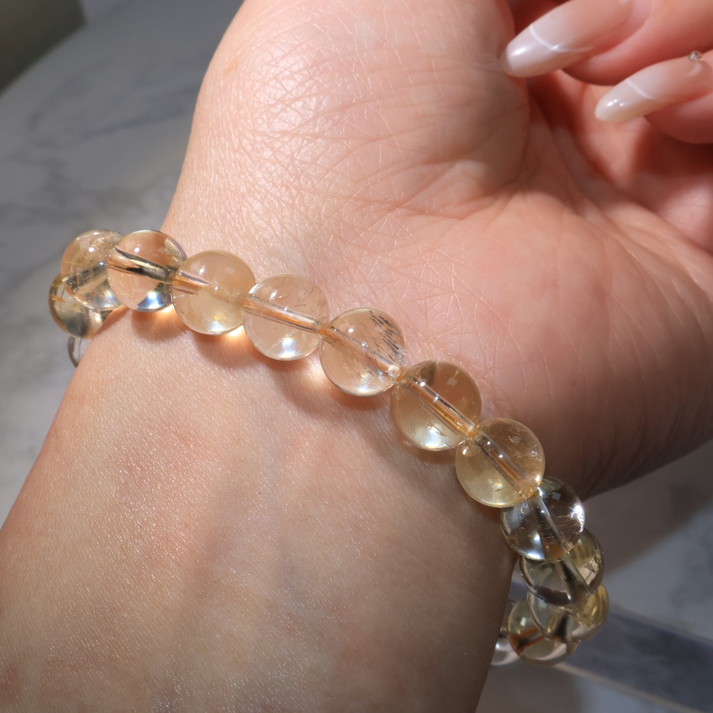 Side view of bracelet on wrist, showcasing natural fingerprints inside beads.