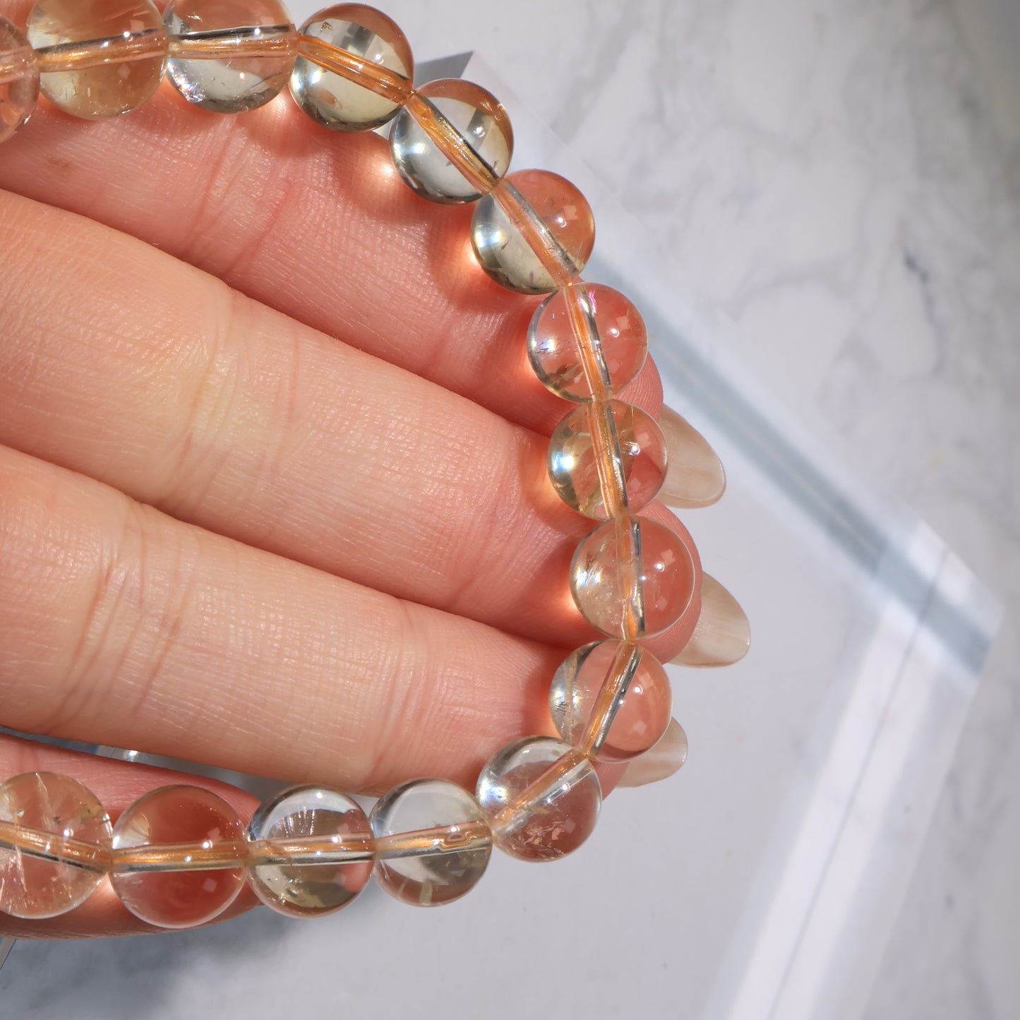 Close-up of polished citrine beads, showing clarity with natural imperfections.