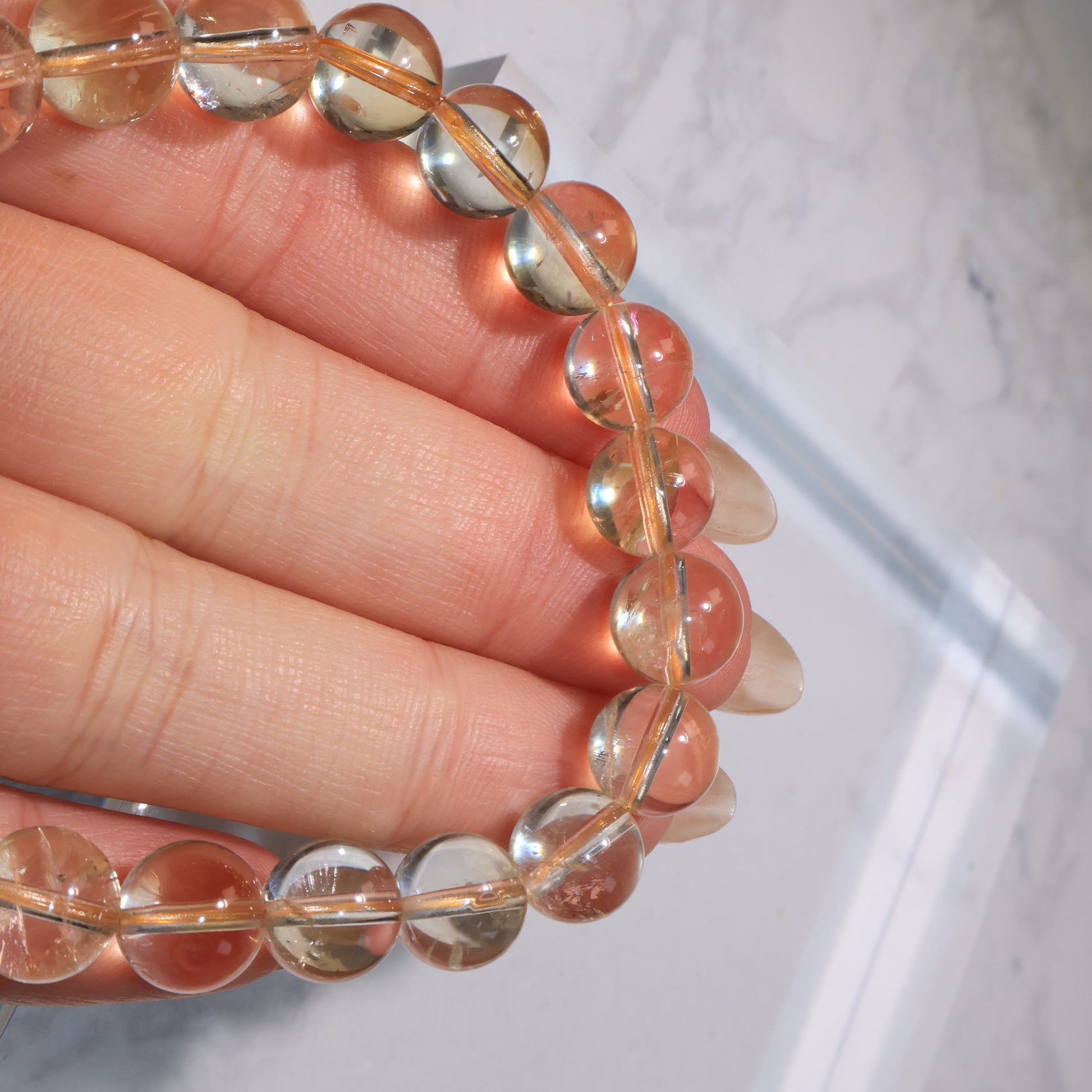 Close-up of polished citrine beads, showing clarity with natural imperfections.
