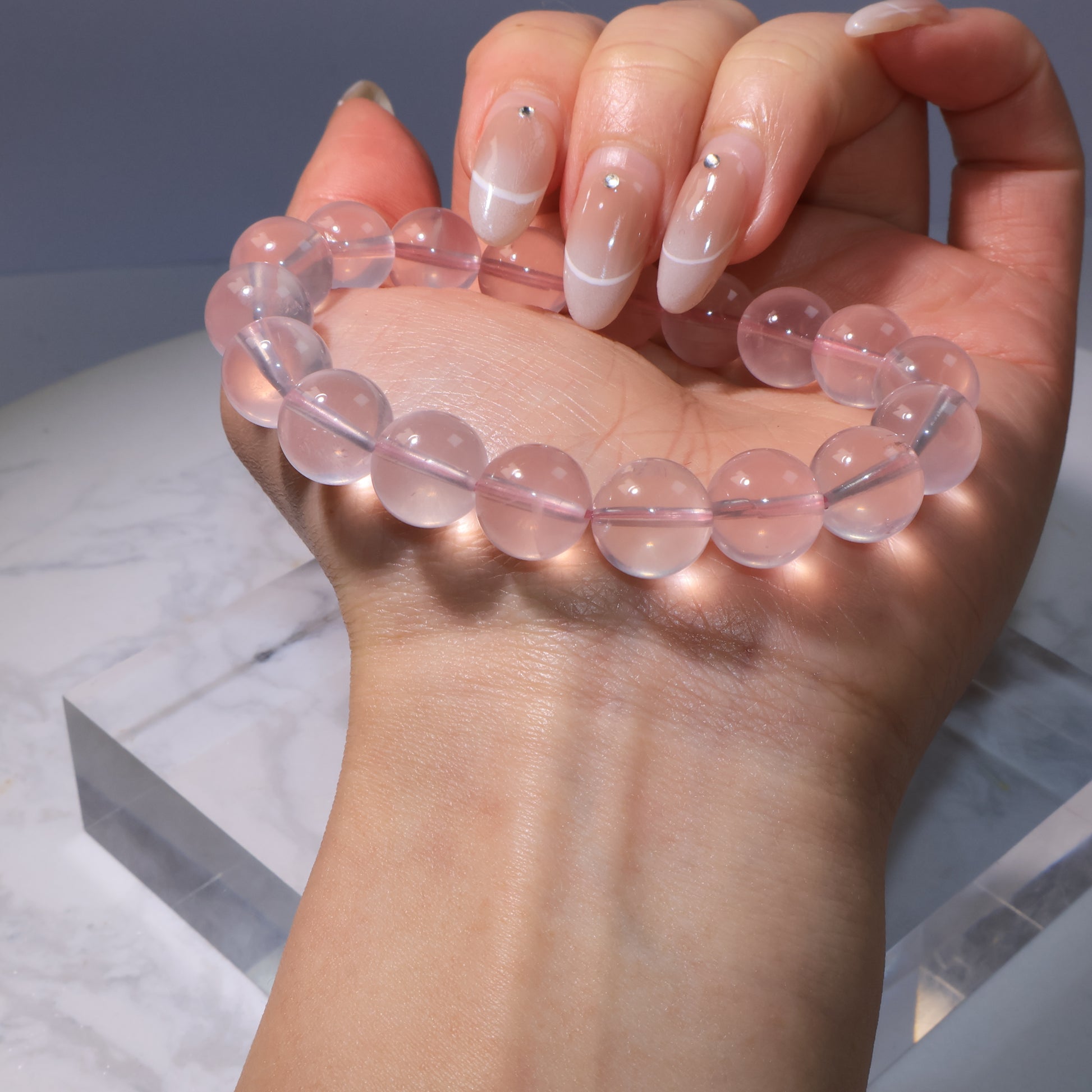 Side view of bracelet, showing smooth polished Rose Quartz beads.