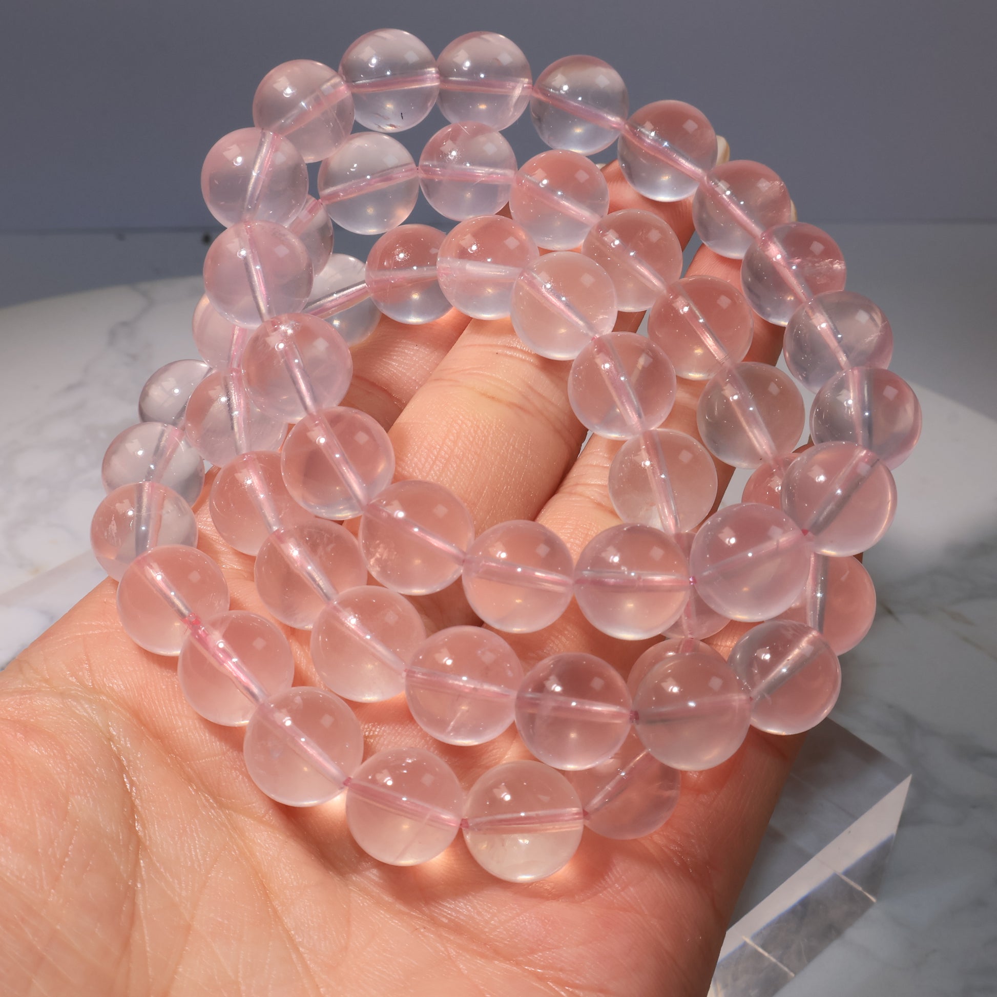 Rose Quartz bracelets grouped together, showing high transparency and luminous shine.