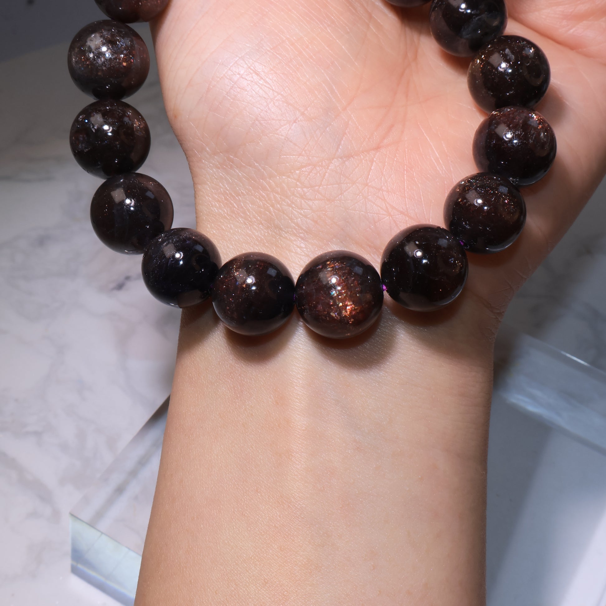 Wrist shot highlighting the translucent beads with mica inclusions｜手腕展示，晶體透亮伴隨雲母質感