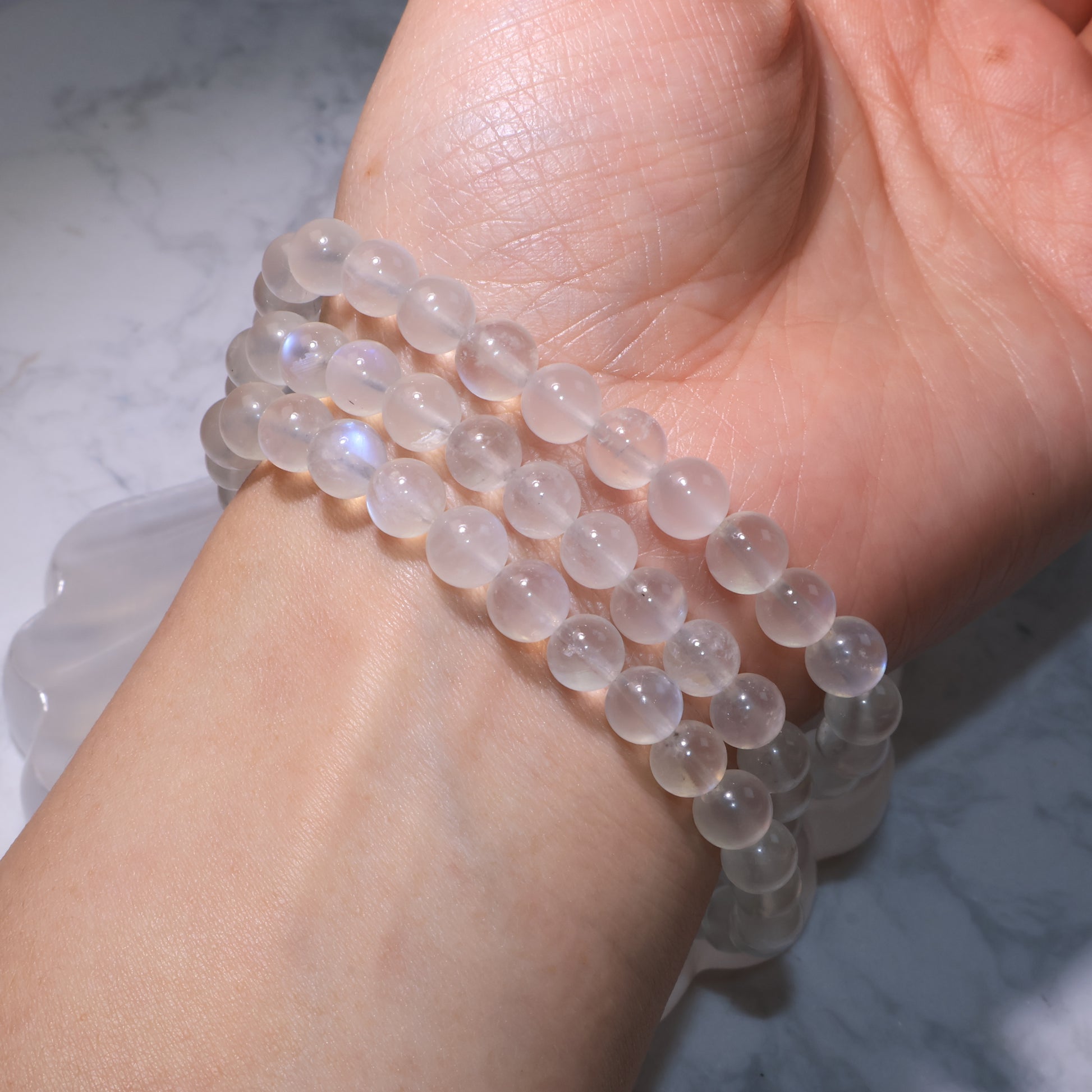 Natural Moonstone bracelet close-up on wrist, displaying its clear texture and light sheen.