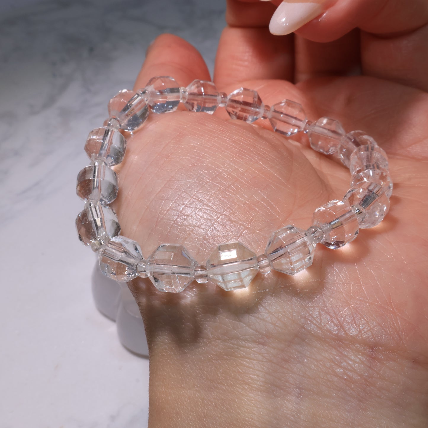 Clear Quartz bracelet resting on the palm, highlighting its luminous clarity.