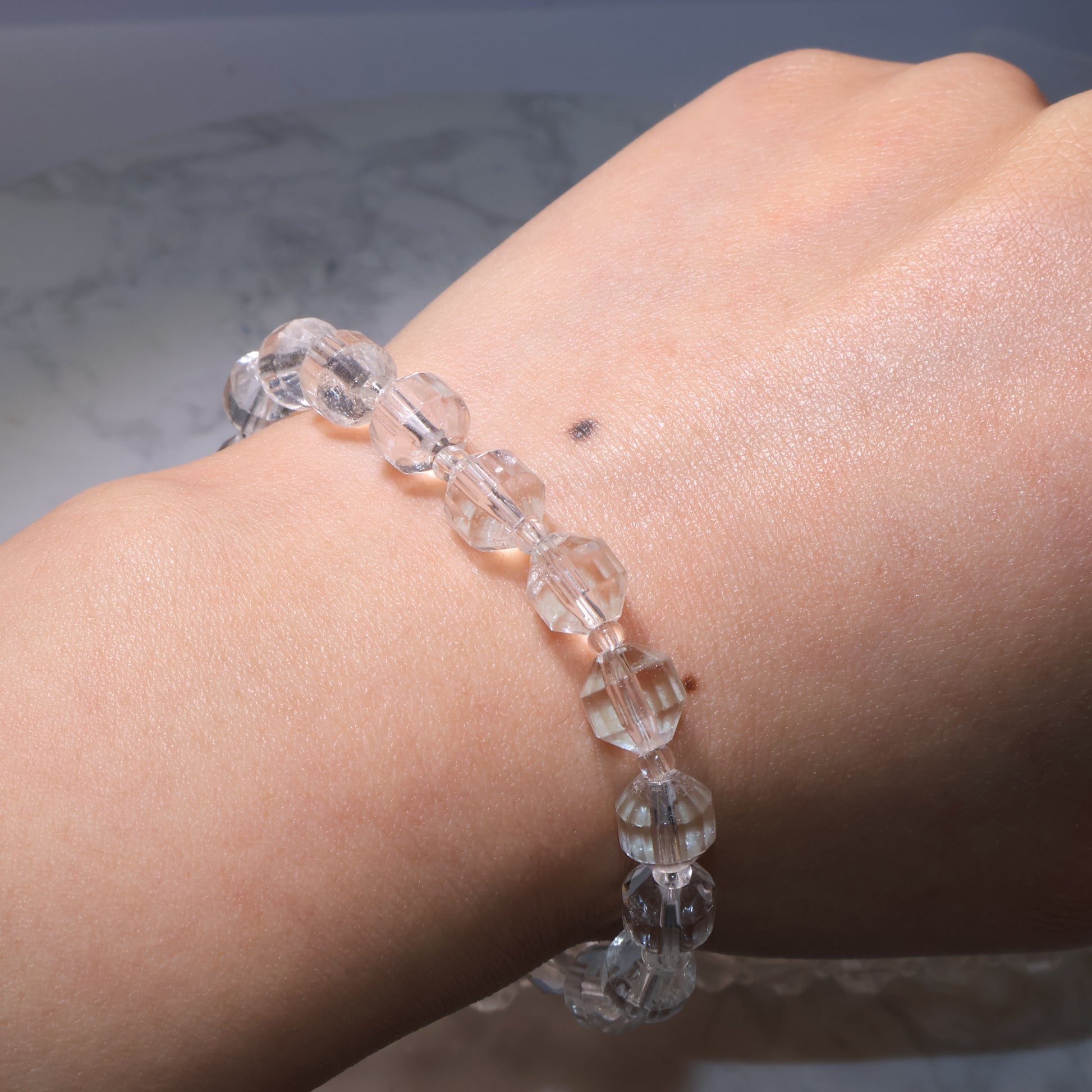 Bracelet worn on the wrist under natural light, showing subtle inclusions.
