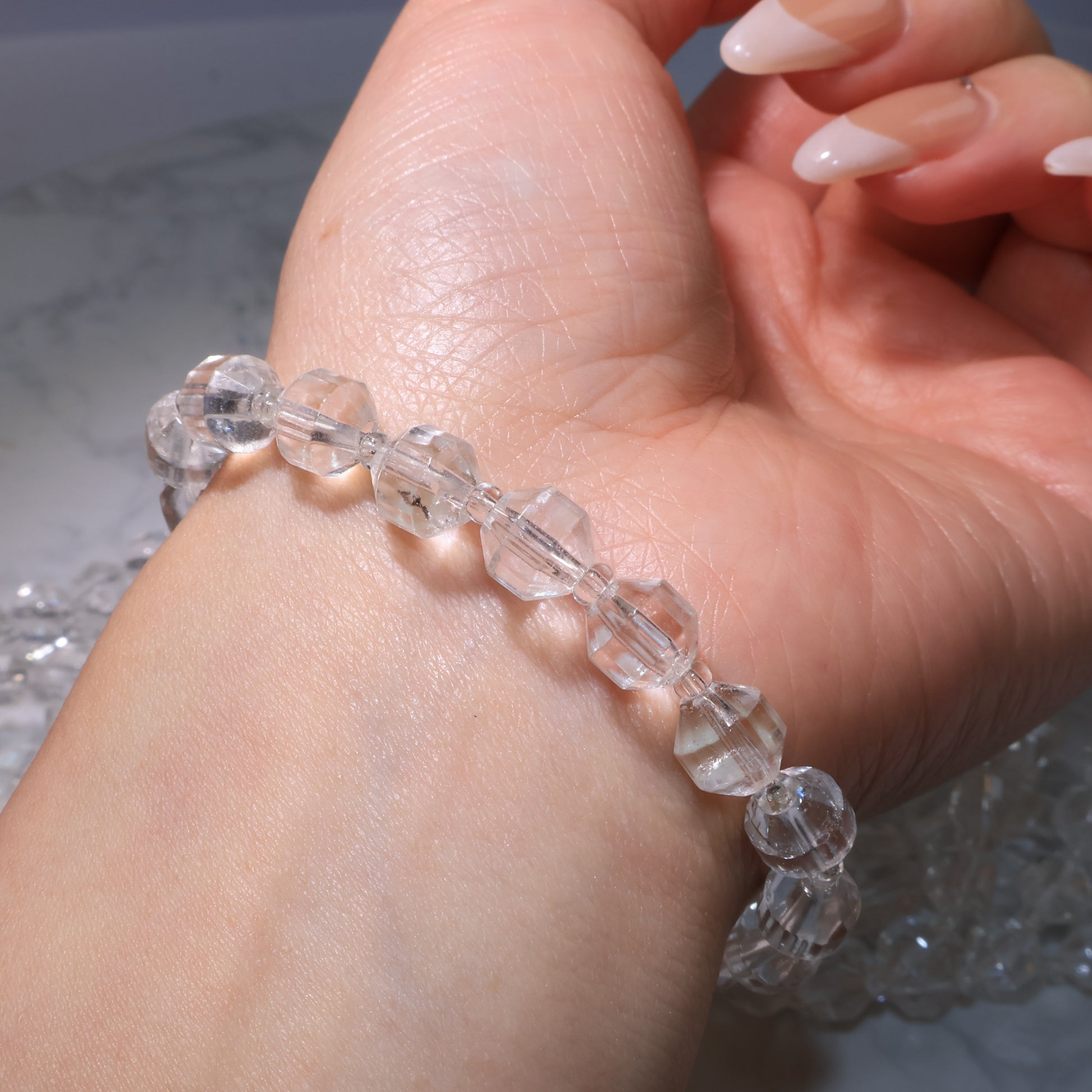 Close-up of Clear Quartz bracelet on the wrist, highlighting clarity and facets.