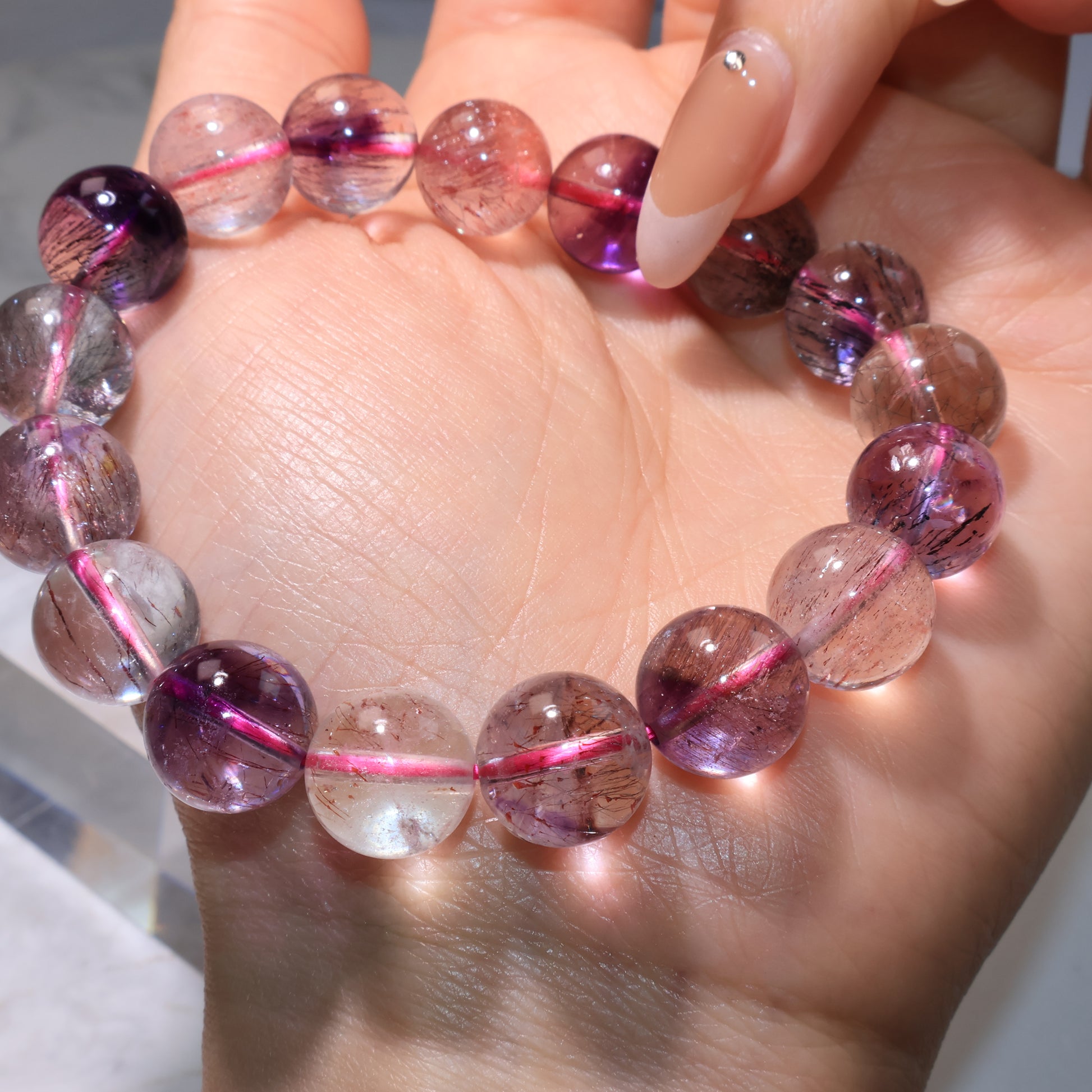 Bracelet glowing under light, revealing internal inclusions and color variations.