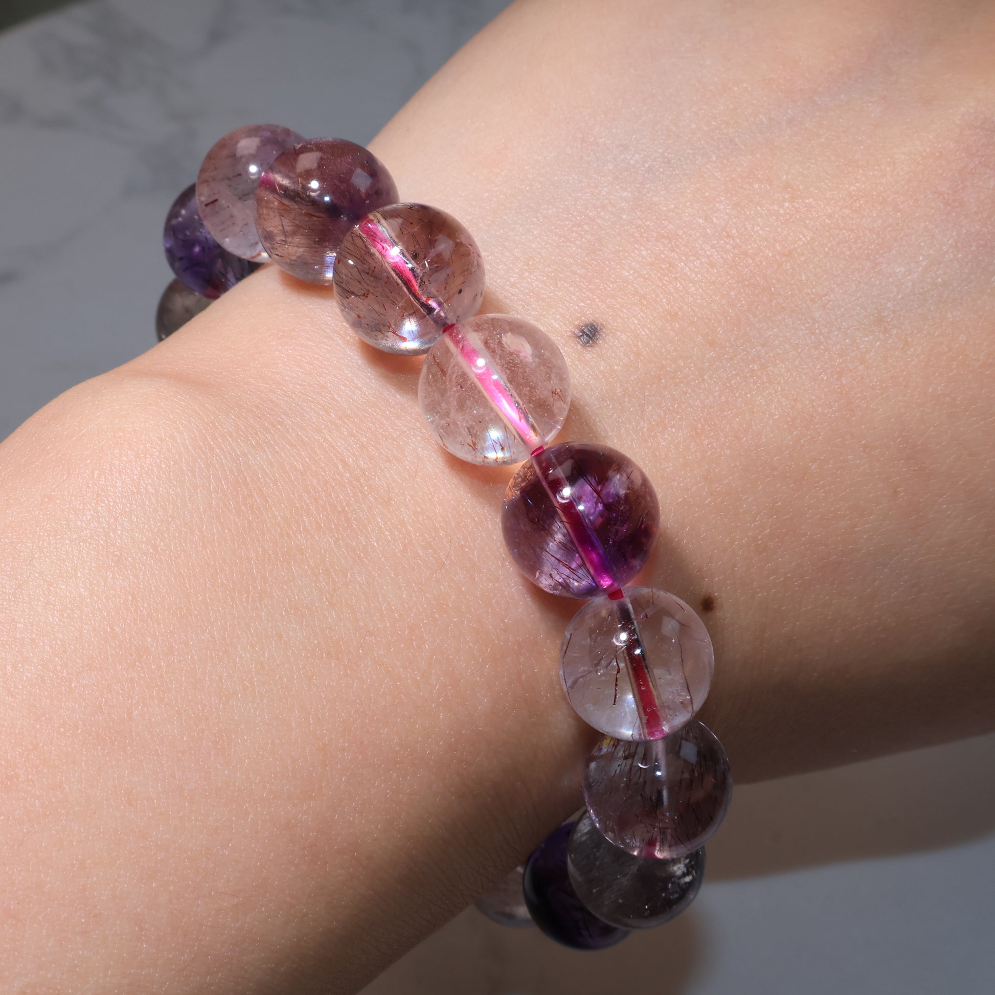 Bracelet worn on wrist, highlighting the natural luster of the Super Seven beads.