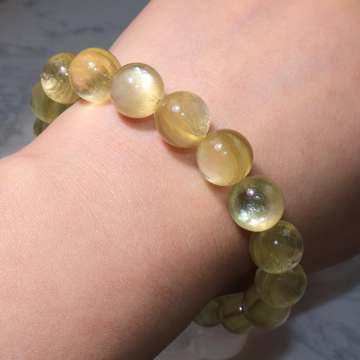 Golden phlogopite bracelet worn on wrist, radiant beads shining with warm golden energy