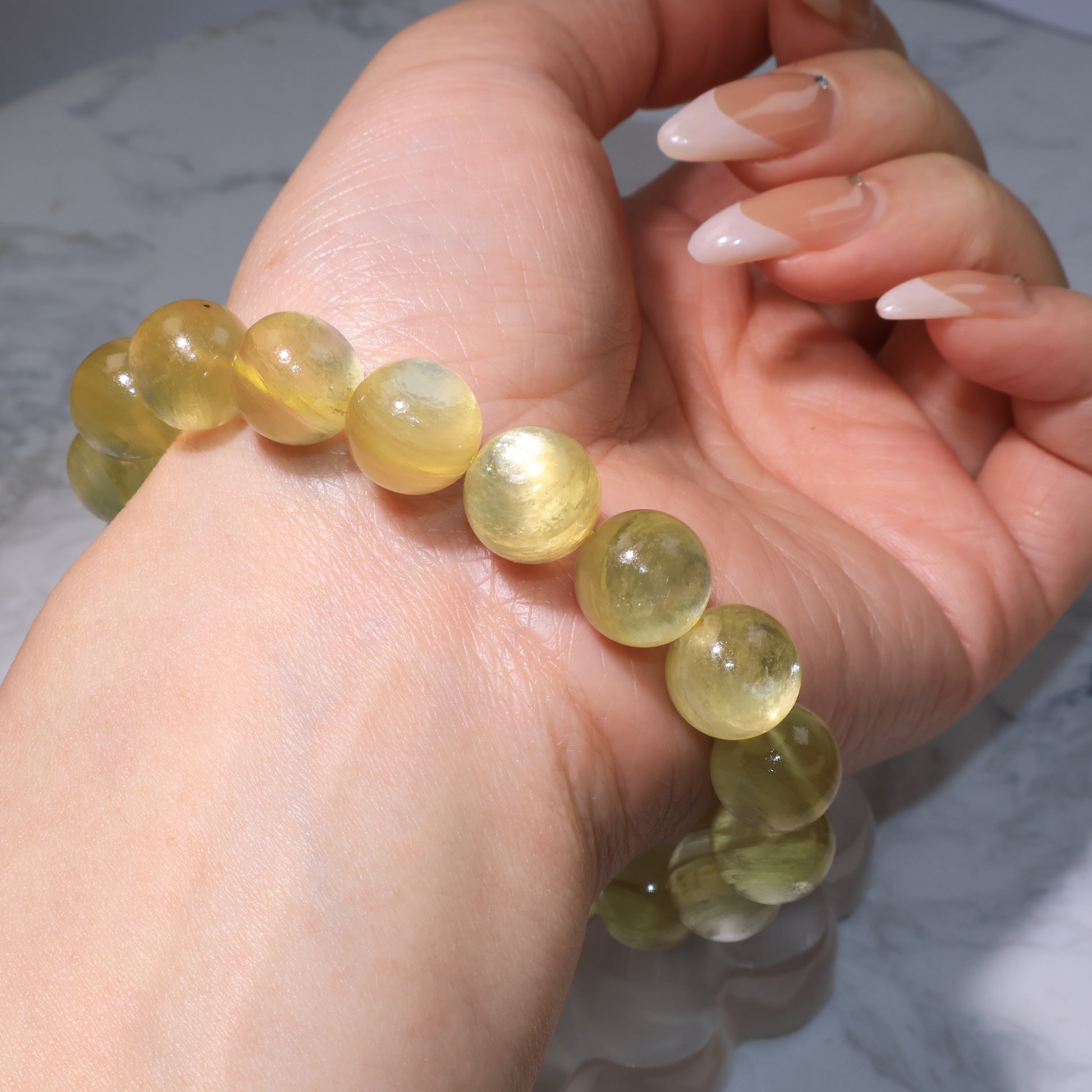 Side view of bracelet on wrist, showing smooth polish and elegant golden luster