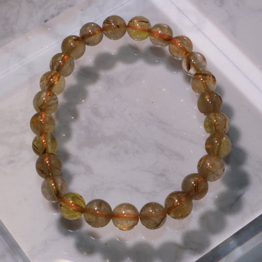 Golden Red Rutilated Quartz bracelet with 8mm beads, golden-red rutile threads shining inside.
