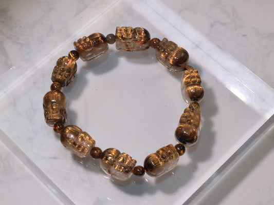 Golden Rutilated Quartz Pixiu Bracelet displayed on acrylic base, showing its golden sheen and clarity.