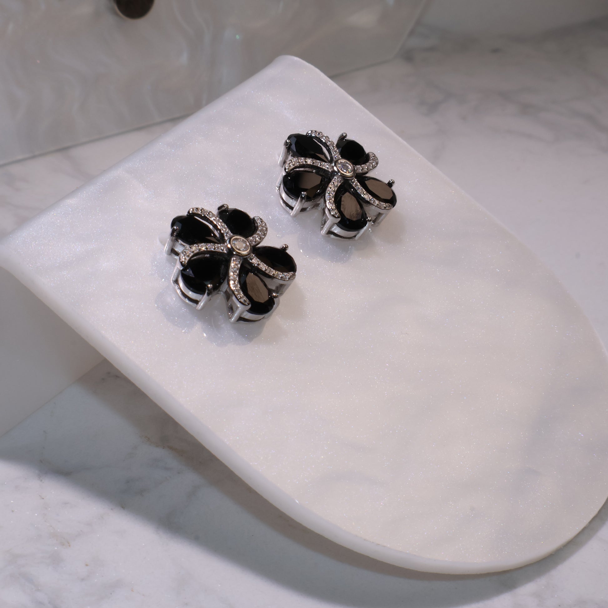 Side angle showing the raised petal design and polished silver details.