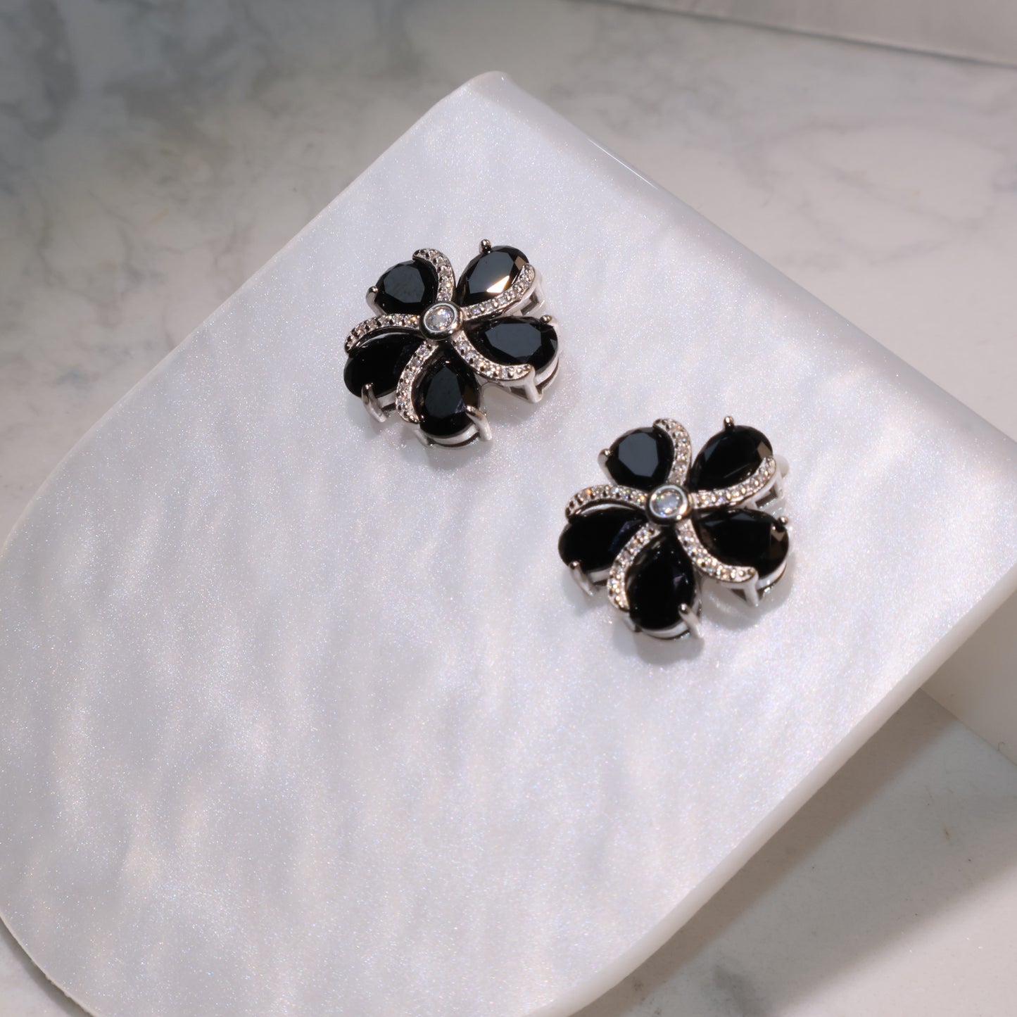 Diagonal shot highlighting the deep black luster of the spinel stones.