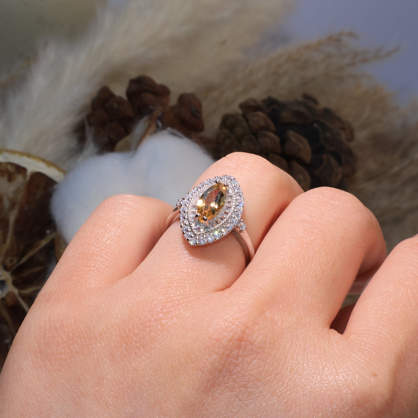 Marquise citrine ring worn on hand, radiating warmth and elegance under soft light.