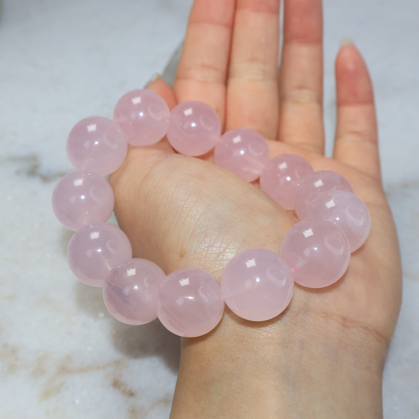 Rose quartz bracelet worn on wrist with glossy polished 17mm beads