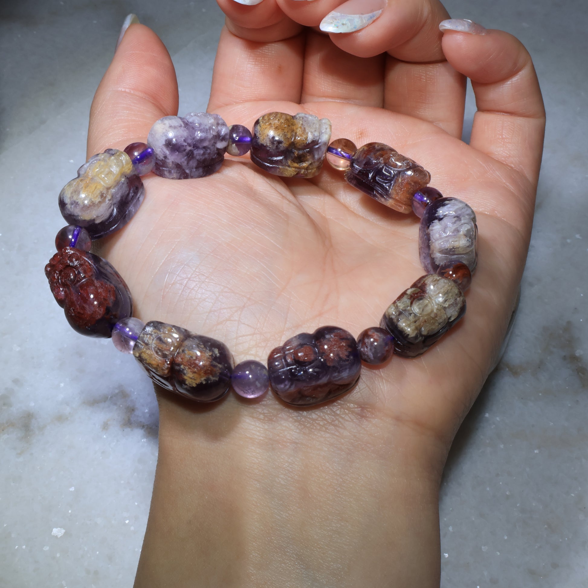Purple phantom quartz Pixiu bracelet worn on wrist showing natural crystal textures