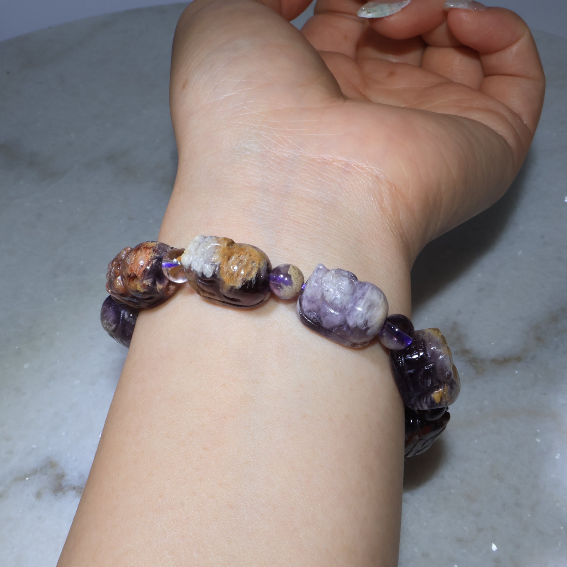 Detailed side angle of purple phantom quartz Pixiu bracelet on wrist