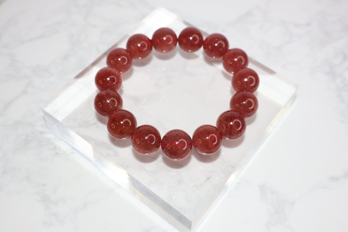 Heart Awakening 14mm strawberry quartz crystal bracelet – deep red beads from Brazil with glossy finish for love and emotional healing.