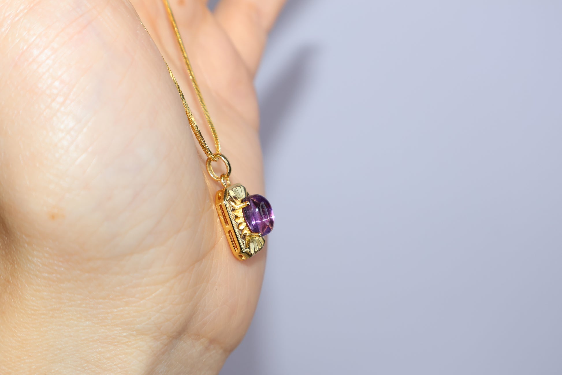 Side view showing the thickness of the amethyst cabochon