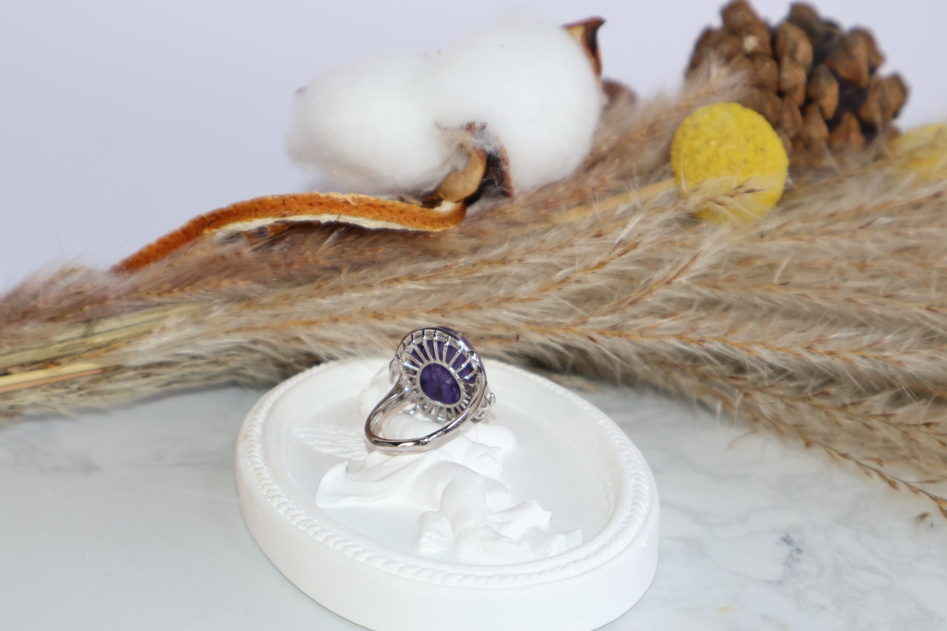 Back of four-prong charoite ring showing silver setting details