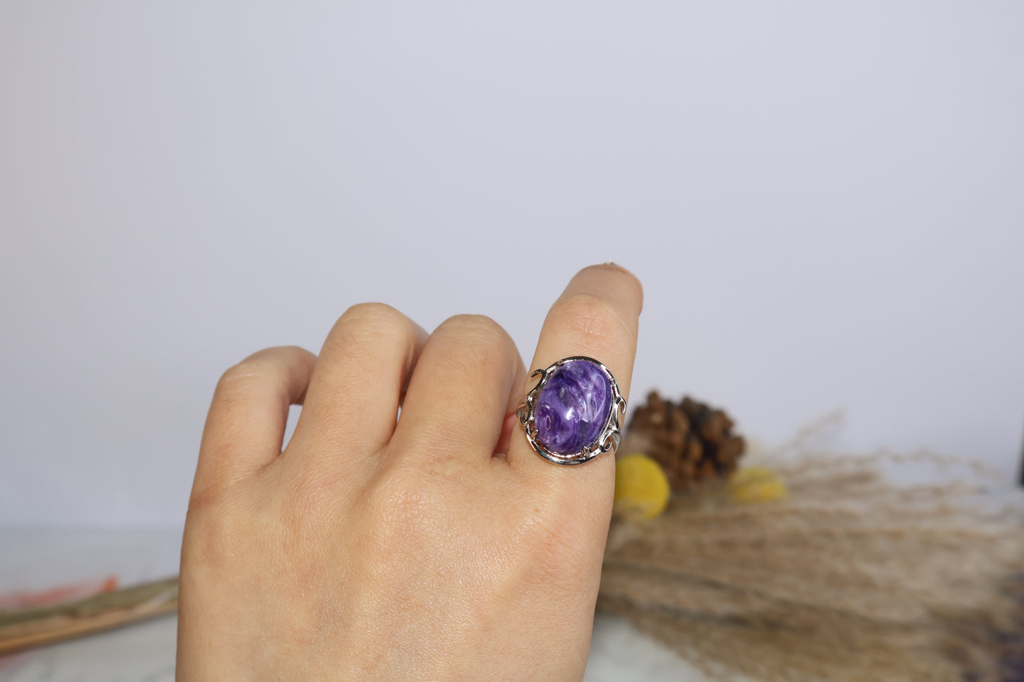 Model wearing adjustable charoite ring, close-up on finger