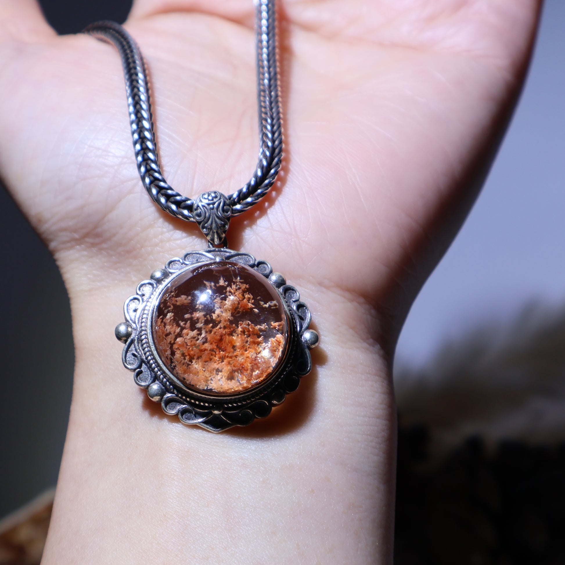 Pendant displayed on hand for size reference