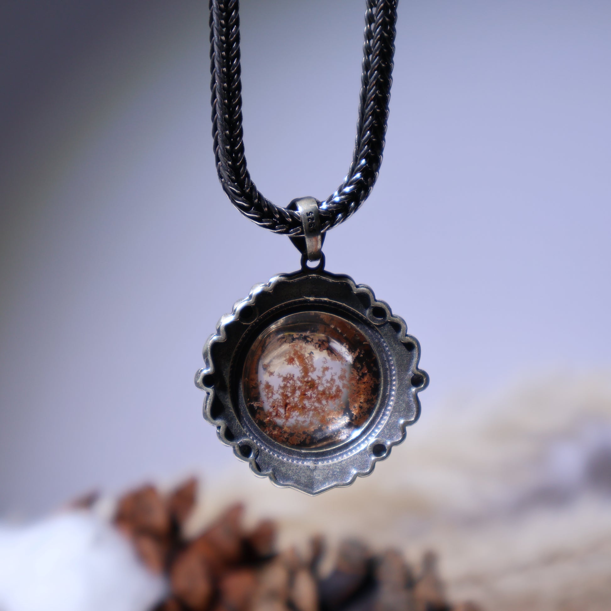 Back view of S925 silver pendant with textured edge